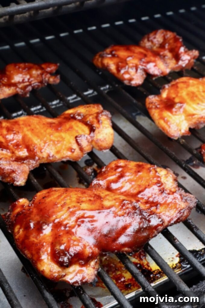Perfectly Smoked Chicken Thighs 7 bbq sauce glazed smoked chicken thighs on a smoker