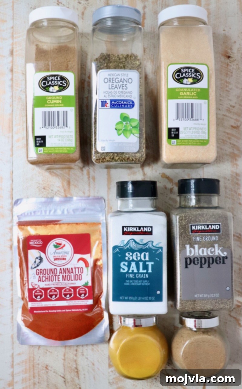 Sazon Spice Blend 3 ingredients for sazon seasoning in containers on a white wood board