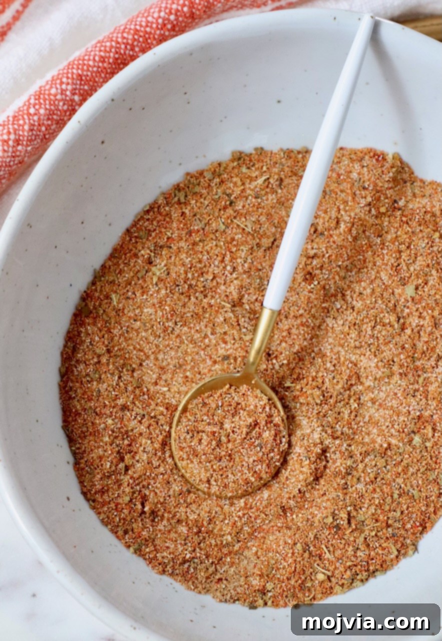 Sazon Spice Blend 5 spices stirred together in a bowl with a small spoon
