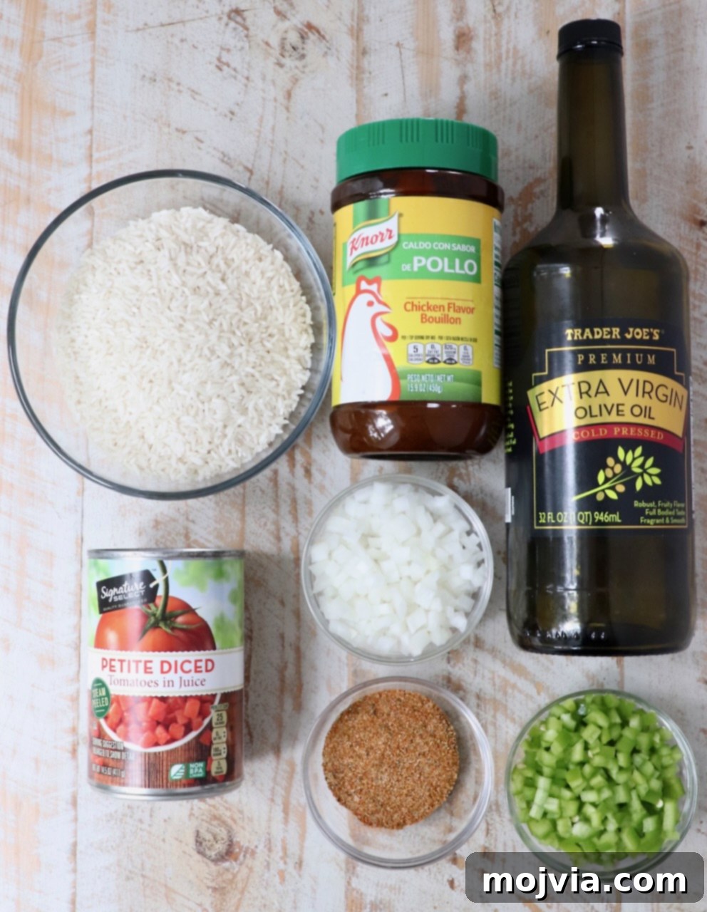 ingredients for yellow rice on a white wood board