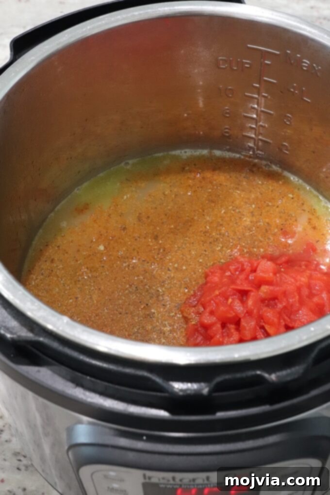 rice, seasoned broth and diced tomatoes in an Instant Pot