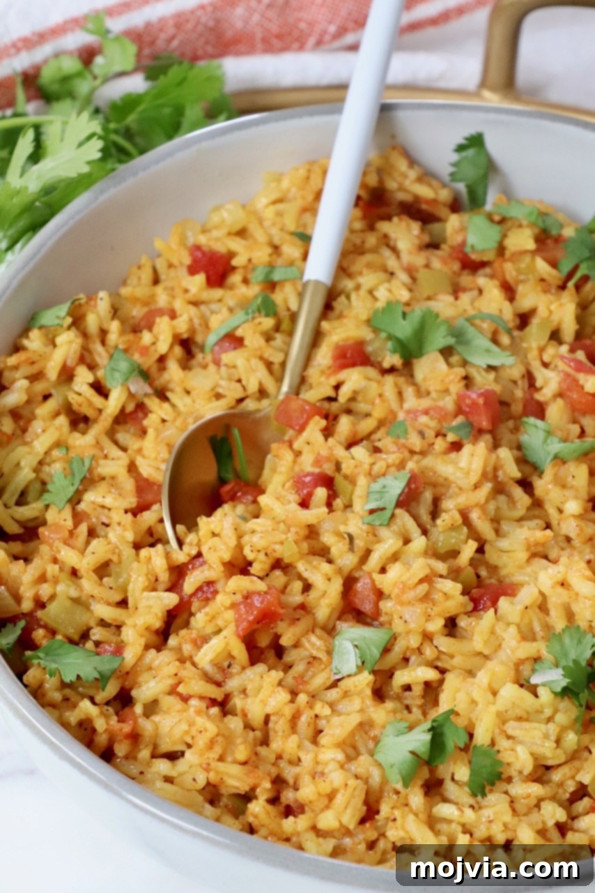 yellow rice in a bowl with a spoon