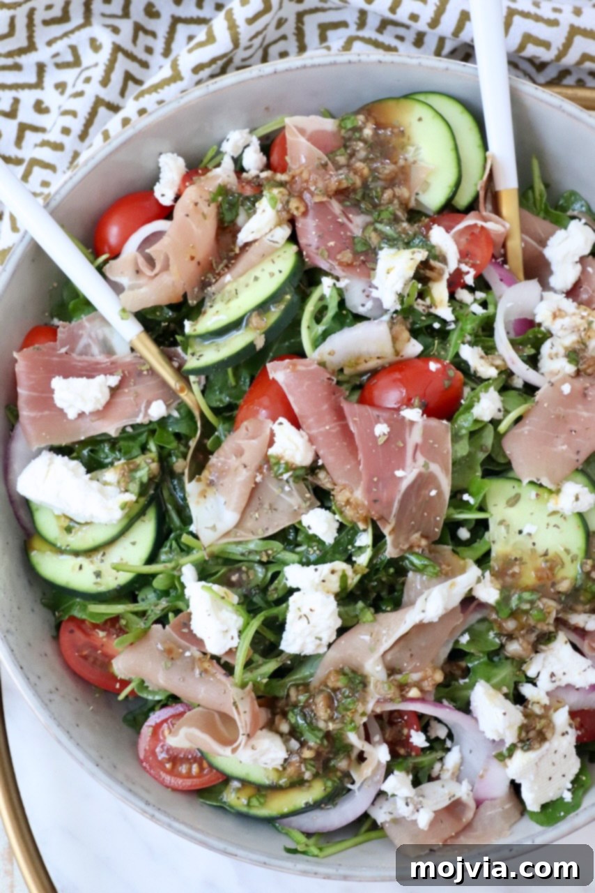 Refreshing Prosciutto Arugula Cucumber Salad 2 Vibrant Cucumber Arugula Prosciutto Salad in a bowl with feta and tomatoes