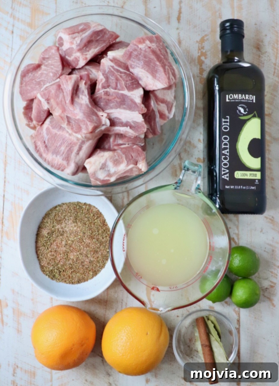 Pork Carnitas 2 ingredients for carnitas on a white wood board