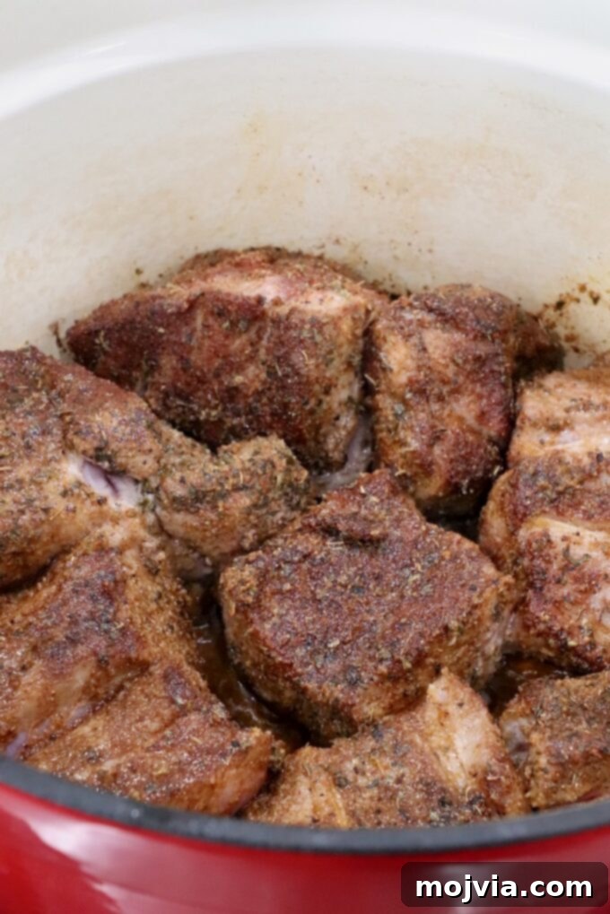 Pork Carnitas 5 seared, seasoned pieces of pork in a large cast iron dutch oven