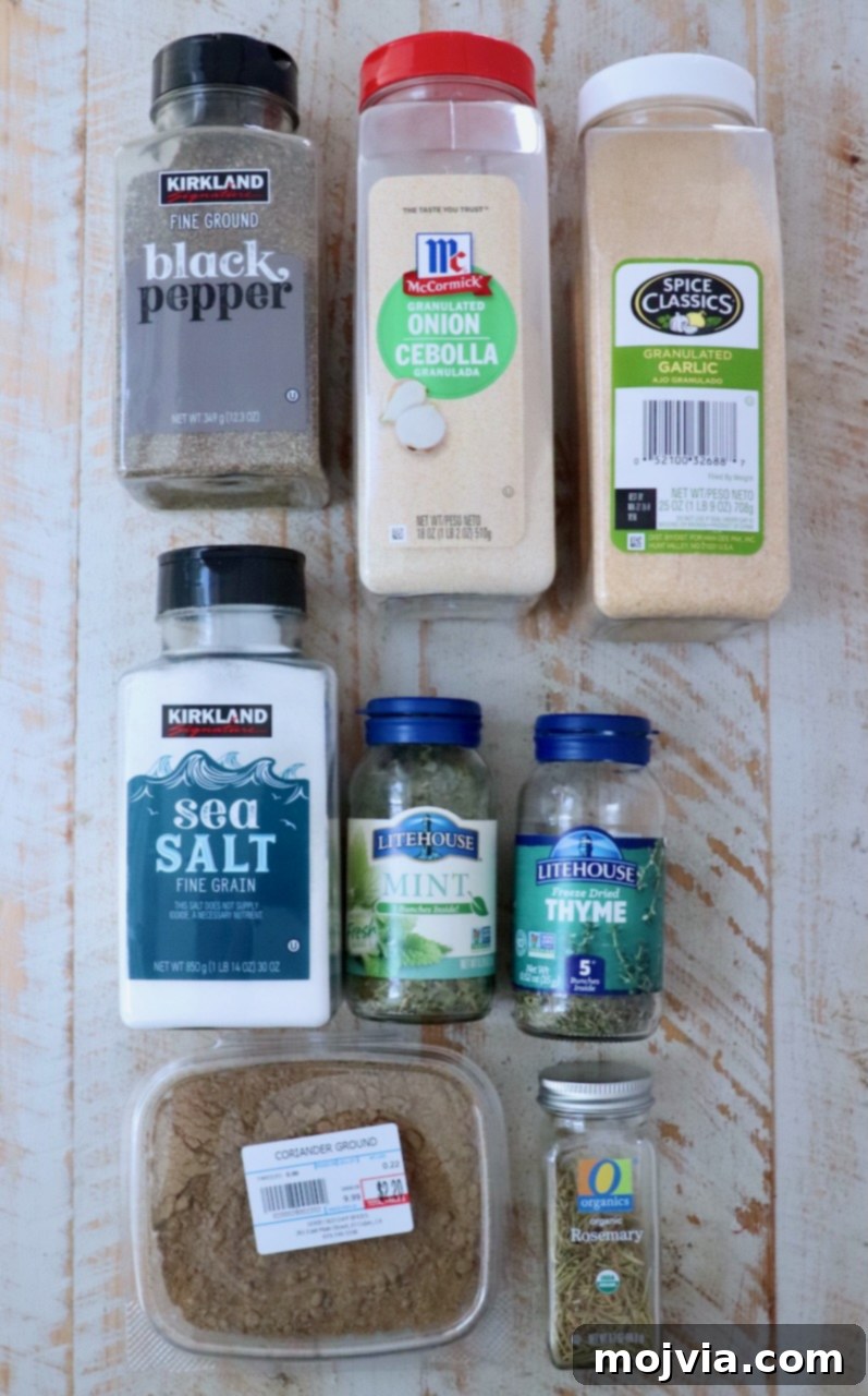 Perfect Lamb Rub 3 assorted dried herbs and spices neatly arranged in plastic containers on a clean white wood board, ready for mixing into lamb seasoning