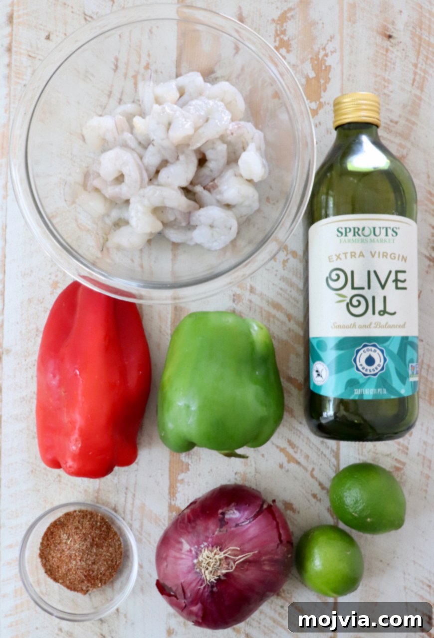 Sizzling Shrimp Fajita Feast 3 ingredients for shrimp fajitas on a white wood board