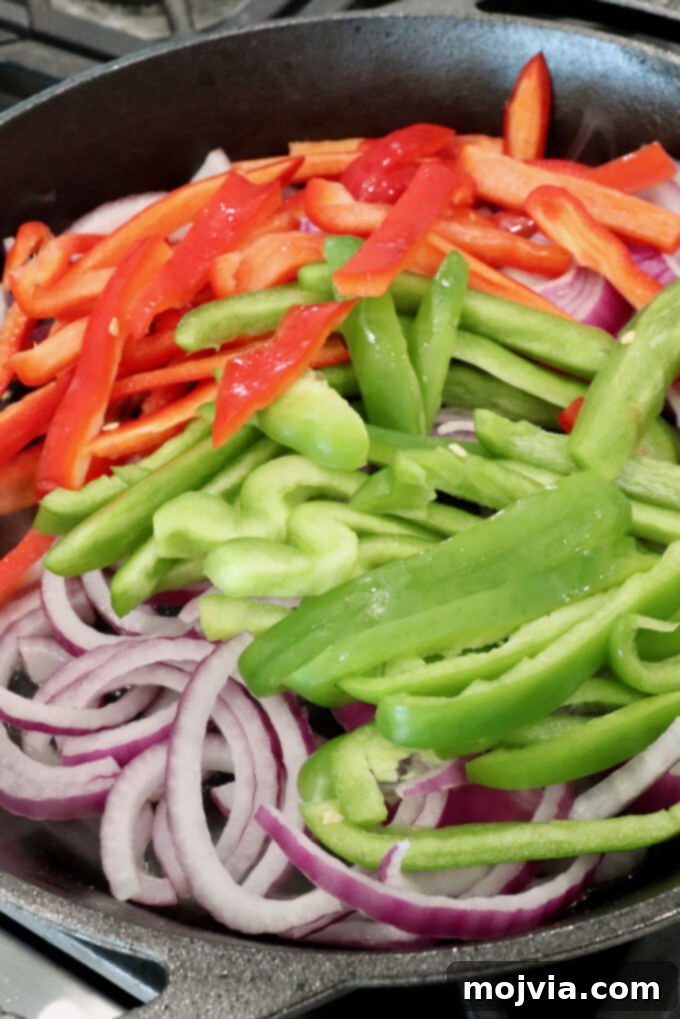 Sizzling Shrimp Fajita Feast 5 sliced bell peppers and onions in a skillet