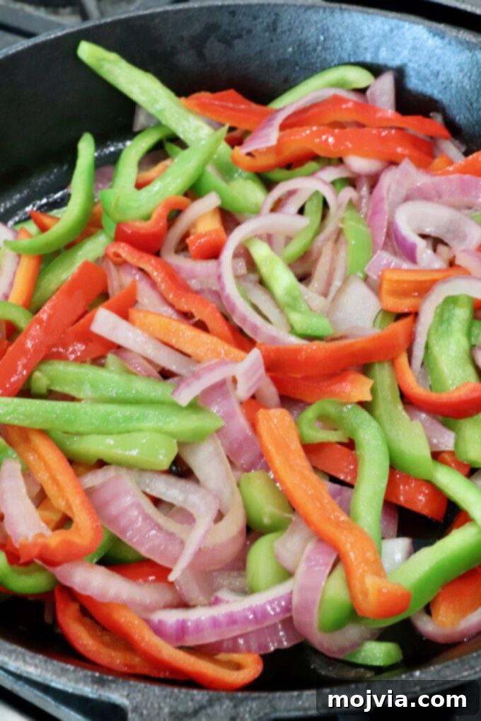 Sizzling Shrimp Fajita Feast 6 sliced bell peppers and onions in a skillet