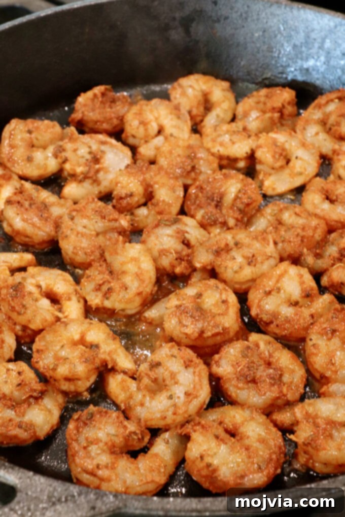 Sizzling Shrimp Fajita Feast 7 seasoned raw shrimp in a cast iron skillet
