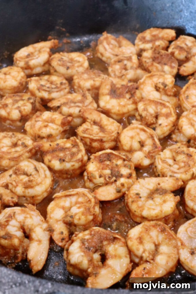 Sizzling Shrimp Fajita Feast 8 seasoned cooked shrimp in a cast iron skillet