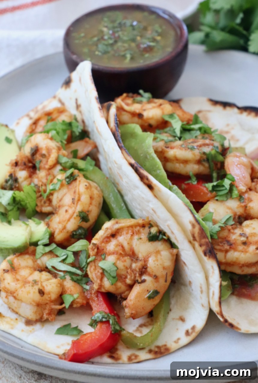 Sizzling Shrimp Fajita Feast 10 shrimp fajitas in tortillas on a plate