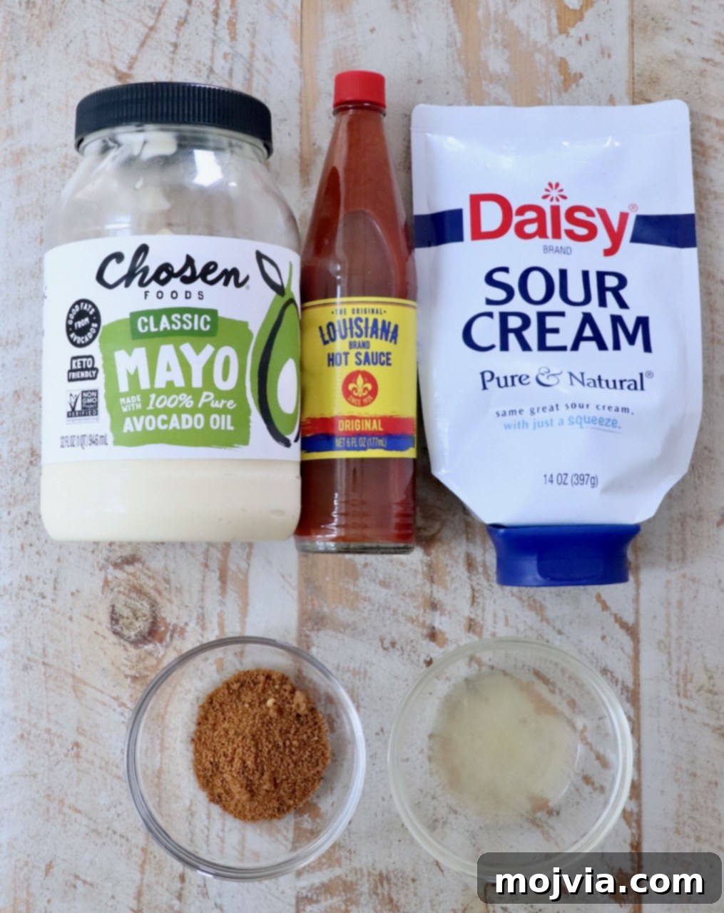 Bold Louisiana Cajun Sauce 3 ingredients for creamy cajun sauce on a white wood board