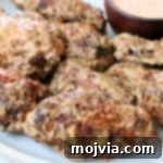 cooked chicken wings tossed in a creamy sauce on a plate