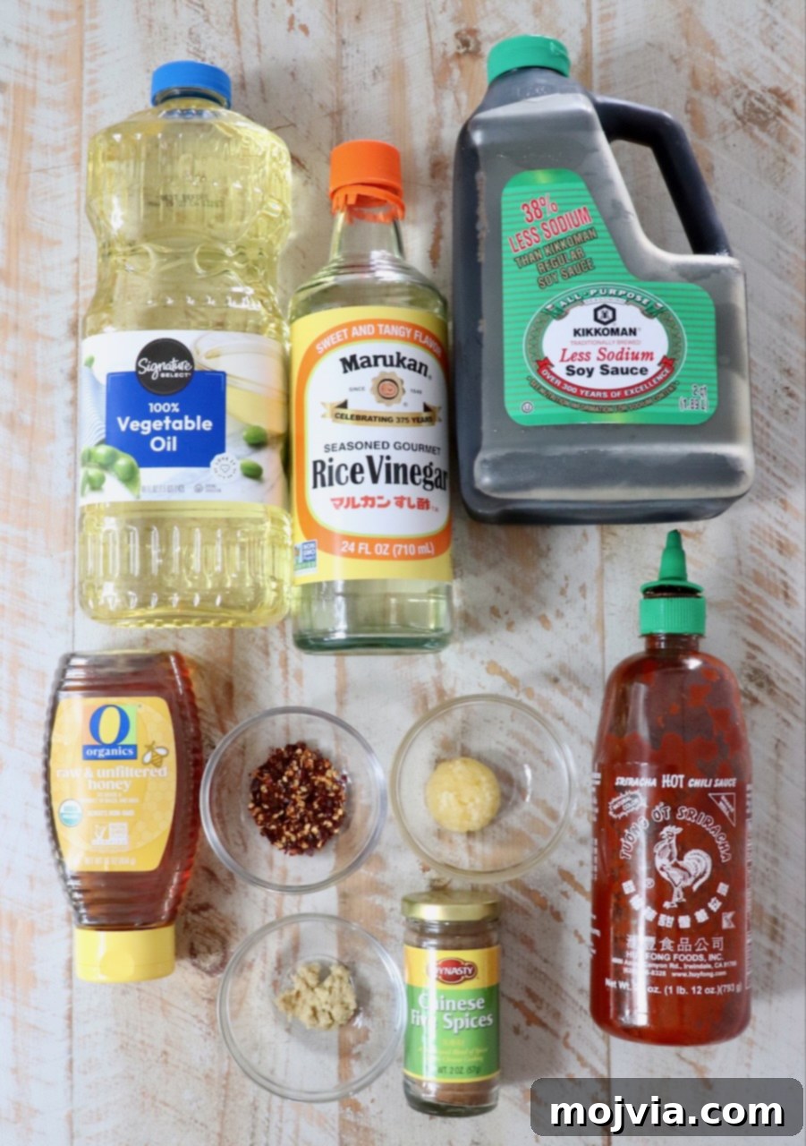 Sticky, Sweet, and Spicy General Tso Sauce 3 All the fresh ingredients for General Tso sauce laid out on a white wooden board, ready for preparation.