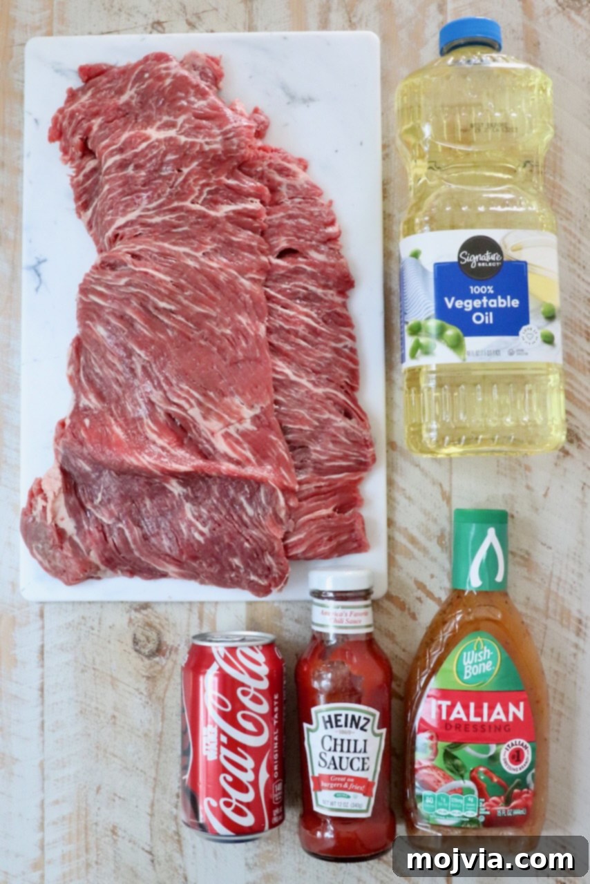 Various ingredients for New England steak tips laid out on a white wooden board