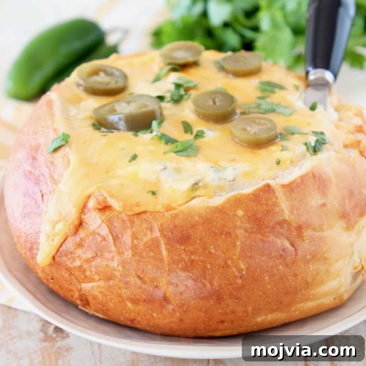 Jalapeno cheese bread bowl with pickled jalapenos and fresh cilantro