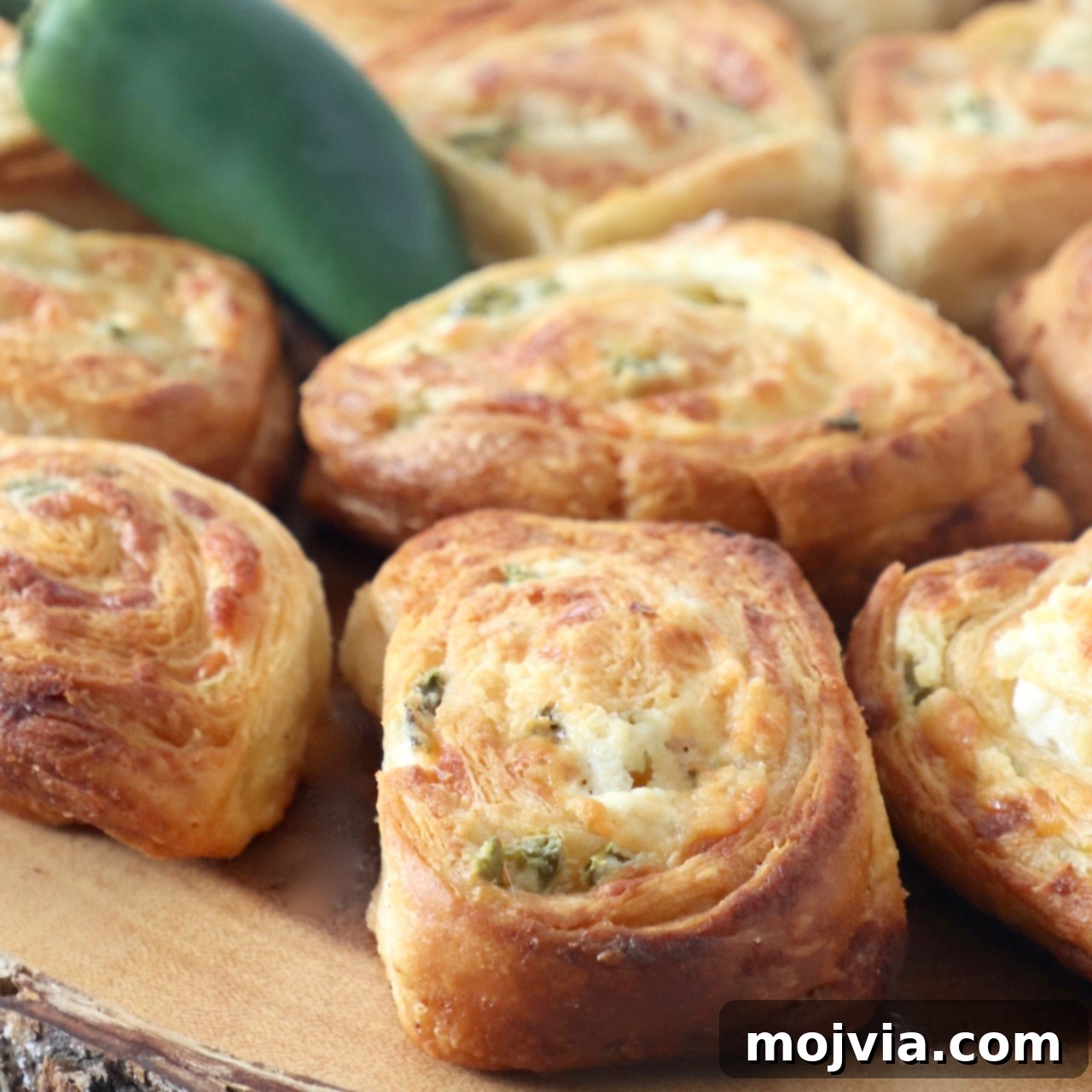jalapeno popper crescent rolls on wood serving tray