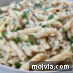 cooked penne pasta in a creamy sauce in a bowl