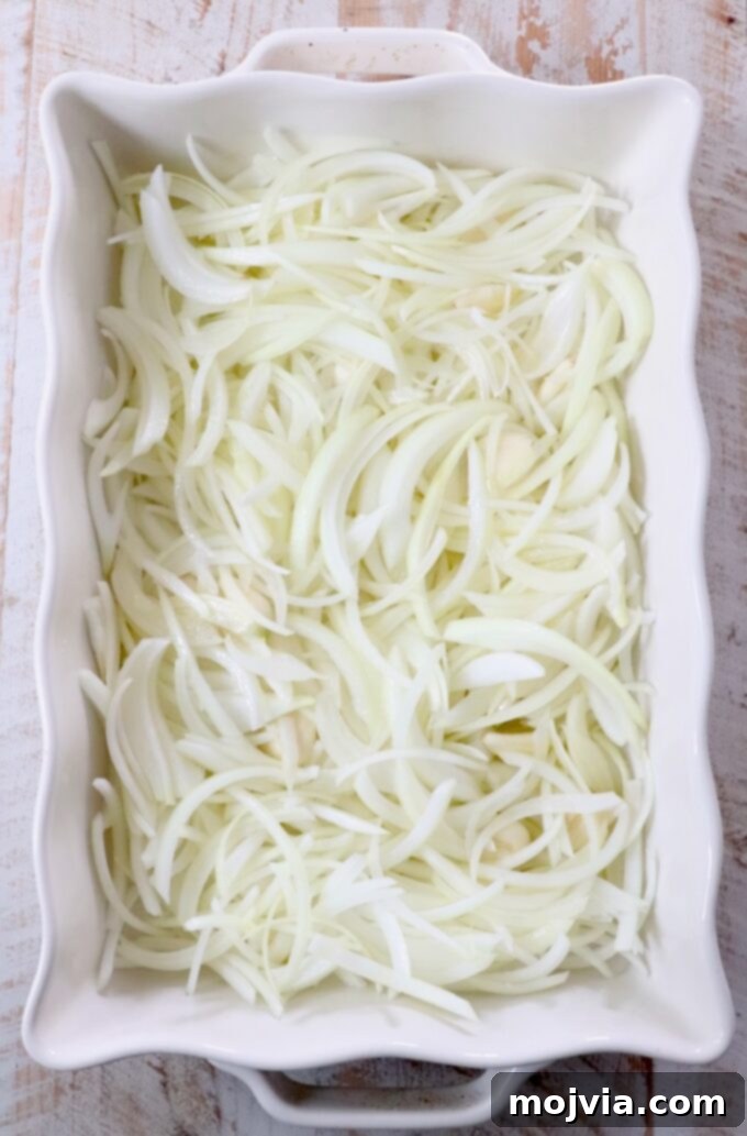 Golden French Onion Boursin Pasta 4 sliced onions in a white casserole dish