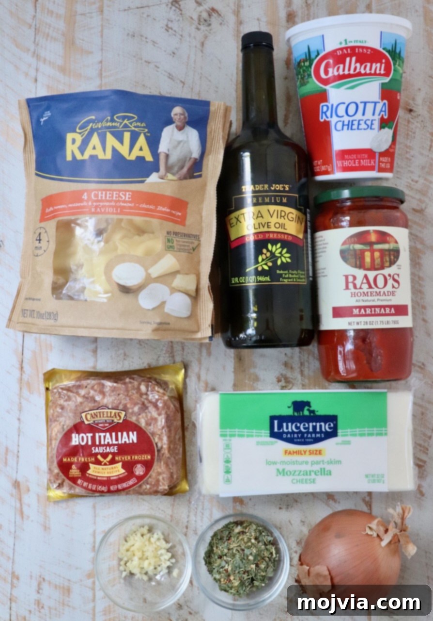 Cheesy Baked Ravioli Delight 3 Assorted Italian ingredients on a wooden surface, including ravioli, olive oil, ricotta, marinara sauce, sausage, mozzarella, garlic, herbs, and an onion.