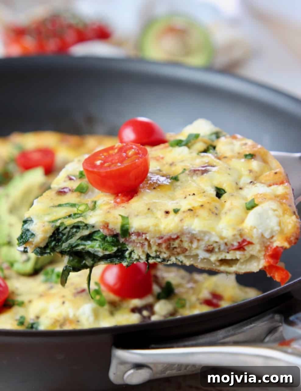 Savory Spinach and Bacon Frittata 2 Slice of frittata on spatula