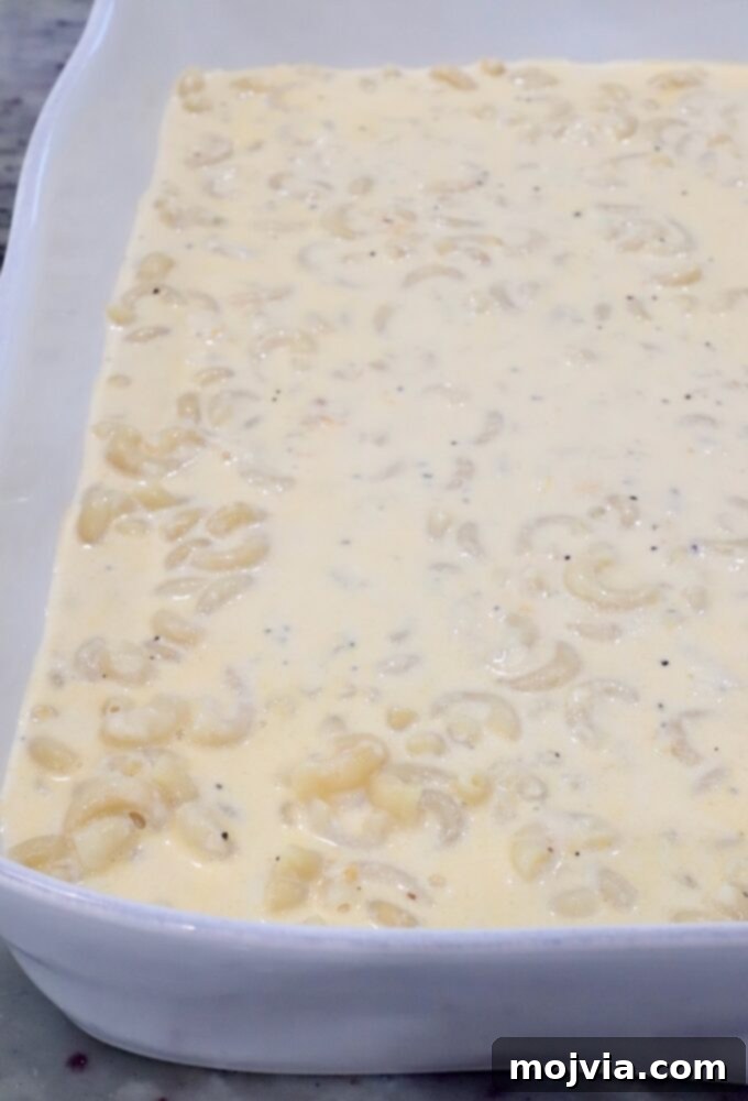 Golden Cheez-It Mac and Cheese Bake 8 A white baking dish filled with macaroni in a creamy, pepper-speckled cheese sauce