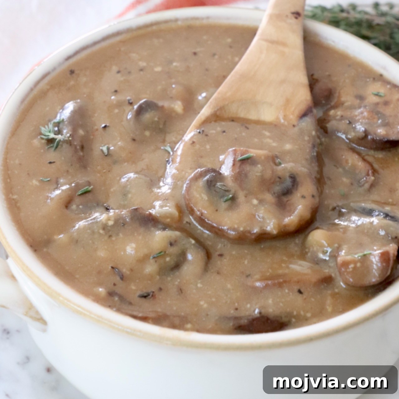 Mushroom gravy in a bowl with a spoon