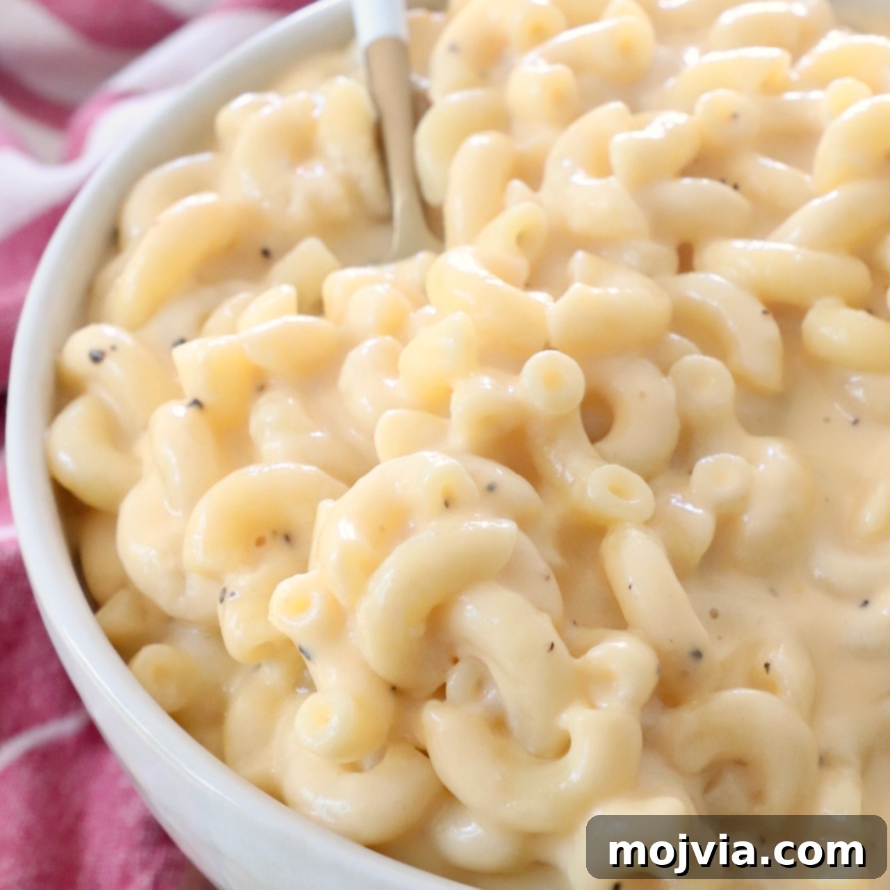 Macaroni and cheese in bowl with fork