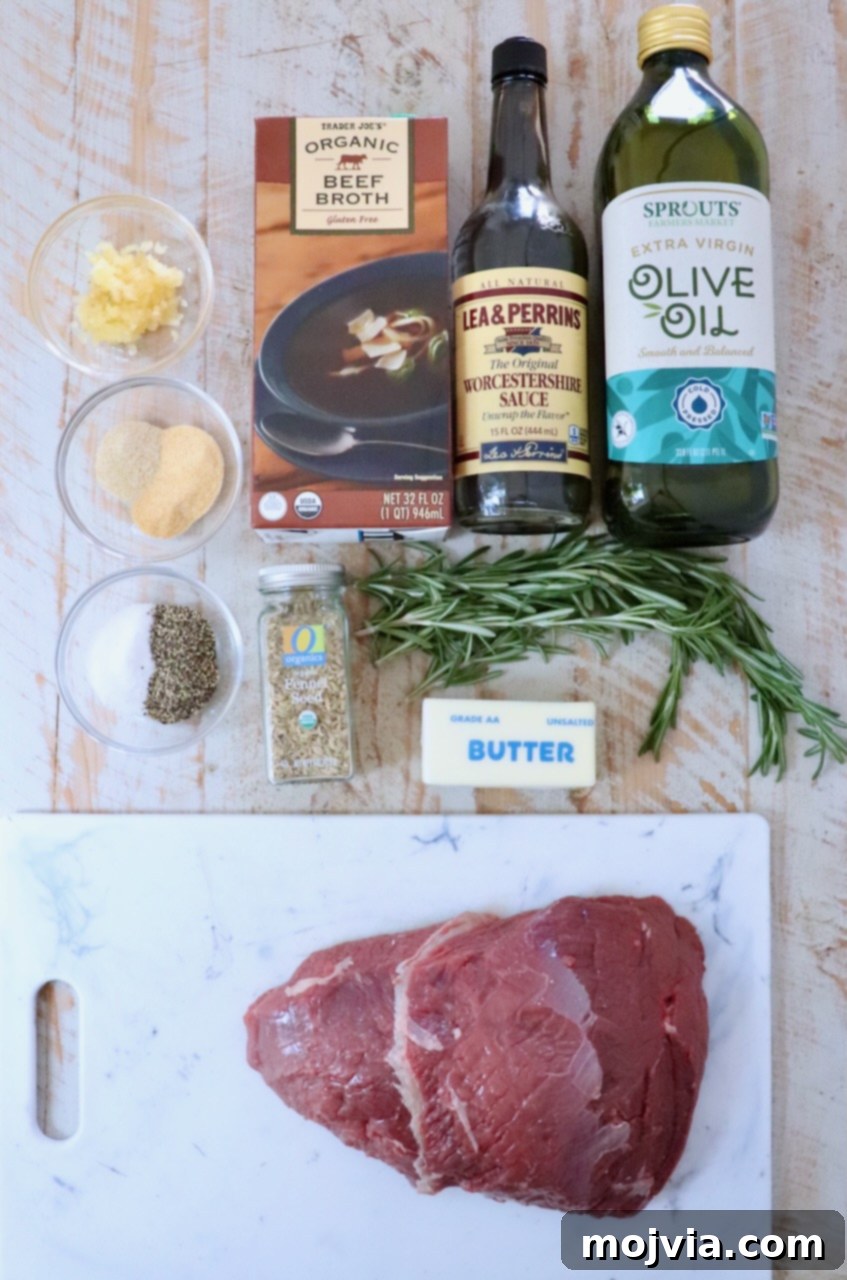 Tender Sirloin Tip Roast 3 Ingredients for cooking a roast, including raw meat on a cutting board, a rosemary sprig, beef broth, olive oil, Worcestershire sauce, spices, and butter.