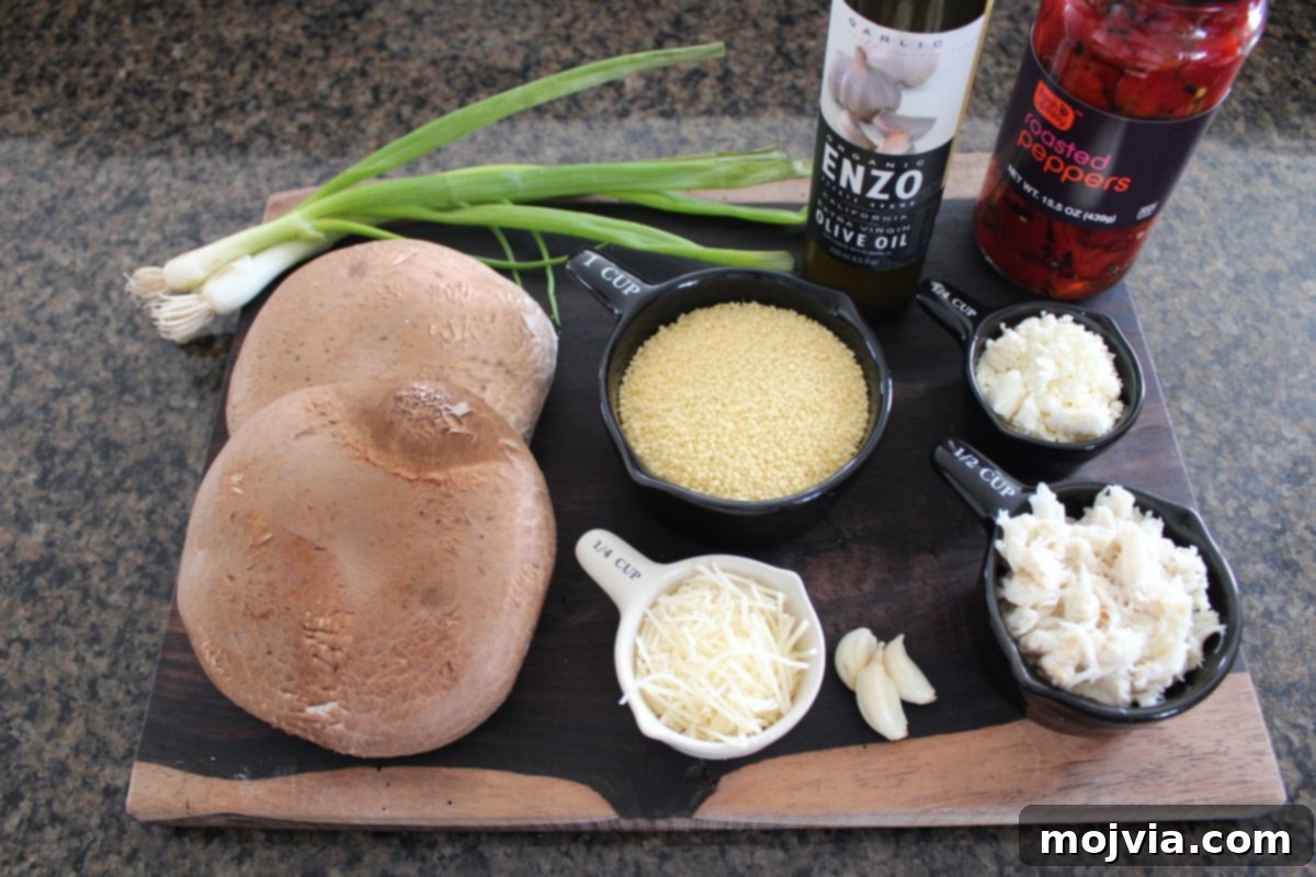 Various fresh ingredients for Mediterranean Crab and Couscous Stuffed Mushrooms, including crab meat, feta, couscous, garlic, red peppers, and green onions, artfully arranged on a rustic wood board, ready for preparation.