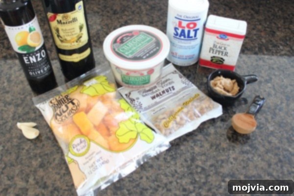 Ingredients for Roasted Butternut Squash and Mozzarella Salad including squash, olive oil, spices, brown sugar, walnuts, balsamic vinegar, garlic, and mozzarella.