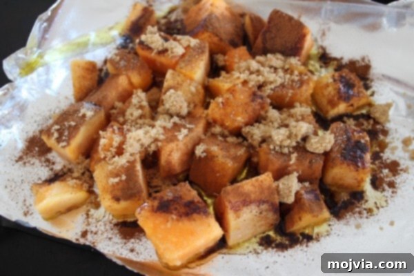 Butternut squash generously coated with brown sugar and cinnamon, ready for roasting to perfection.