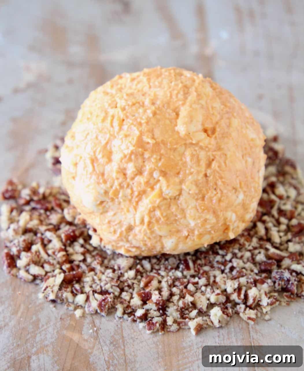 Buffalo Kicked Cheddar Cream Cheese Ball 4 A step-by-step image collage illustrating the process of making a buffalo cream cheese ball.
