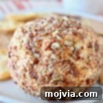 Buffalo Kicked Cheddar Cream Cheese Ball 6 Buffalo cream cheese ball rolled in crushed pecans, ready to be served.