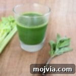 Refreshing Celery Pear Healthy Green Juice in a glass.