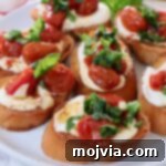 whipped ricotta and roasted tomato bruschetta on a plate