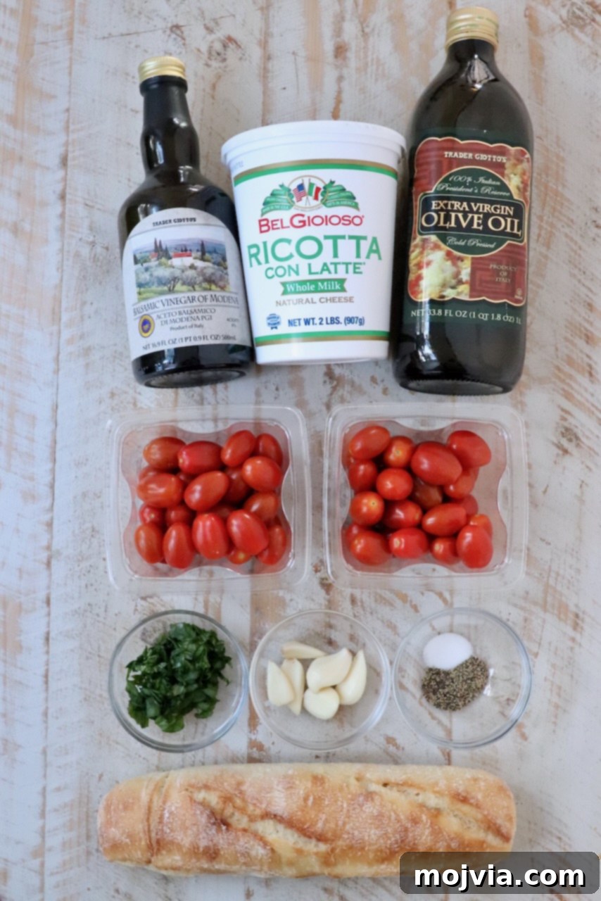 Golden Roasted Tomato Bruschetta with Whipped Ricotta 3 ingredients for tomato ricotta bruschetta on a white wood board