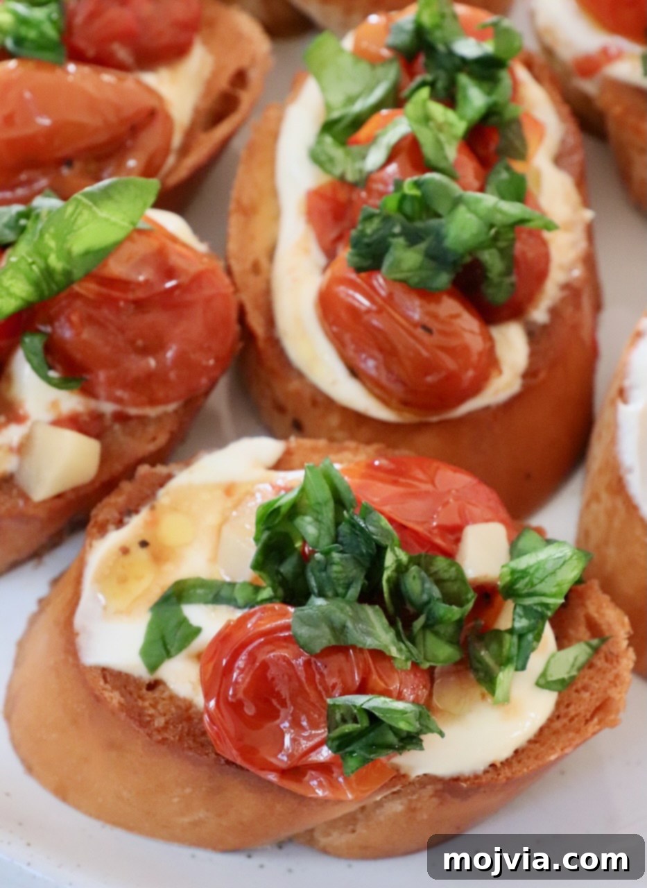 Golden Roasted Tomato Bruschetta with Whipped Ricotta 7 roasted tomatoes and basil on top of ricotta cheese on toast