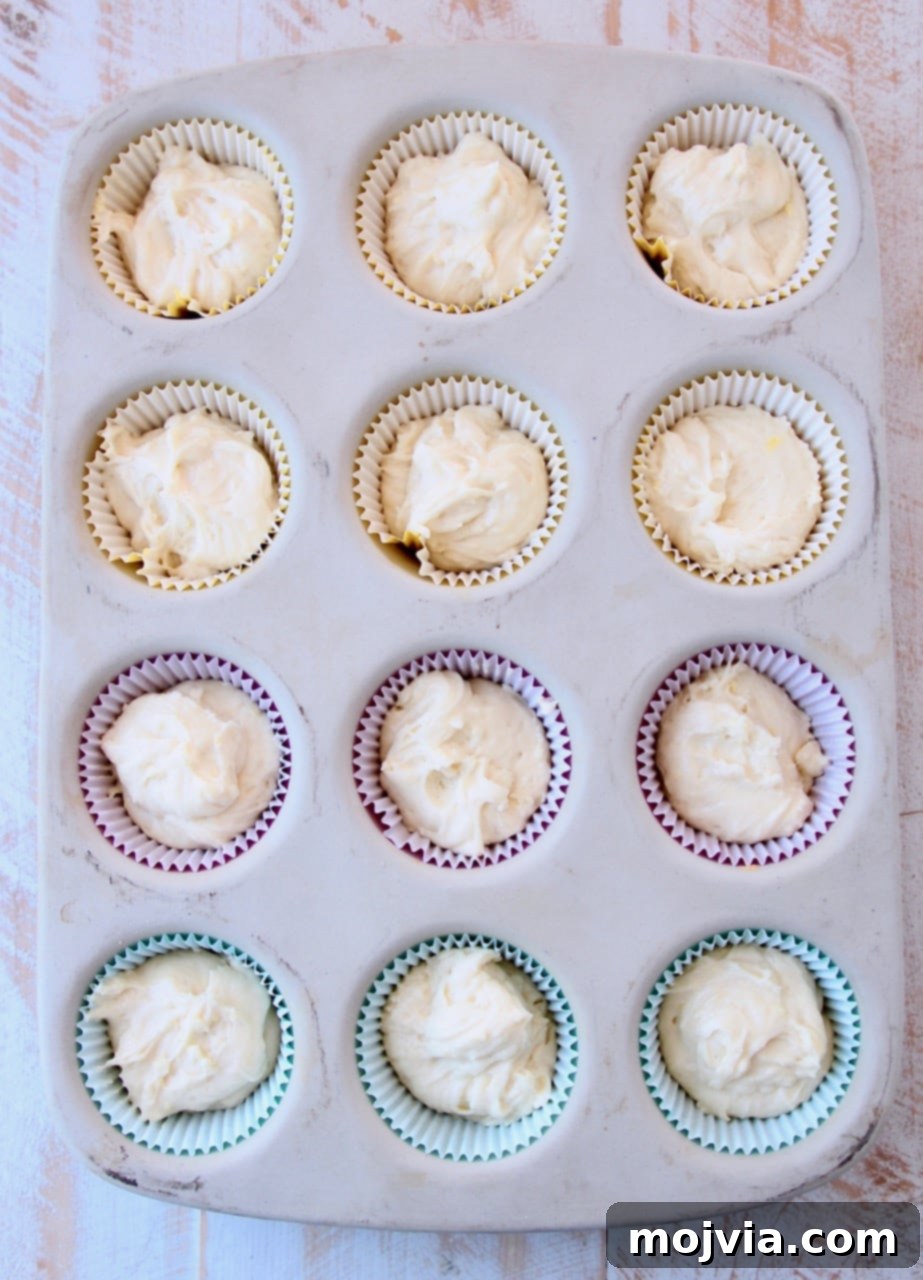 Zesty Lemon Buttercream Cupcakes 4 Cupcake batter in paper liners in stone muffin pan