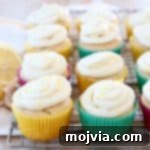 Zesty Lemon Buttercream Cupcakes 6 Lemon cupcakes with cream cheese frosting sitting on wire cooling rack