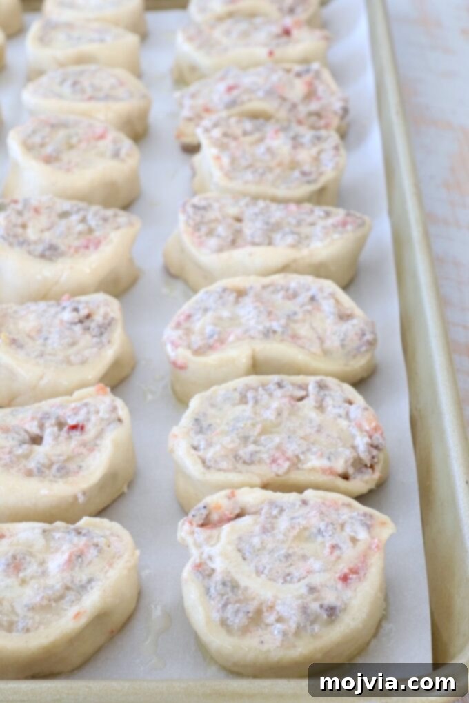 Sausage Cream Cheese Crescents 9 Uncooked pastry pinwheels on a baking sheet