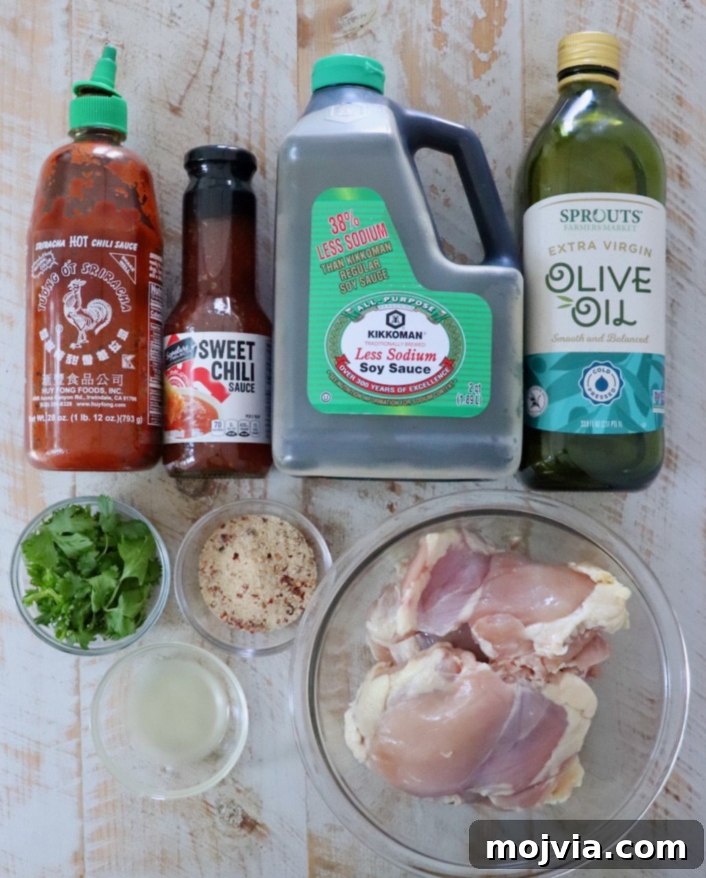 Thai Chicken Delight 3 Ingredients for Grilled Thai Chicken: Sriracha, sweet chili sauce, soy sauce, olive oil, cilantro, Thai seasoning, lime juice, and chicken thighs.