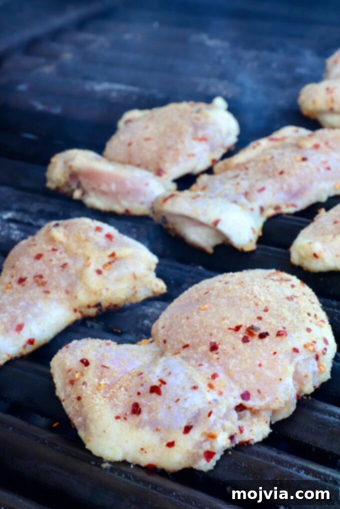 Thai Chicken Delight 6 Seasoned chicken thighs grilling on a BBQ.