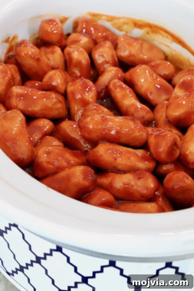 Chipotle Honey Glazed Cocktail Smokies 5 Little Smokies in a crockpot with chipotle honey sauce