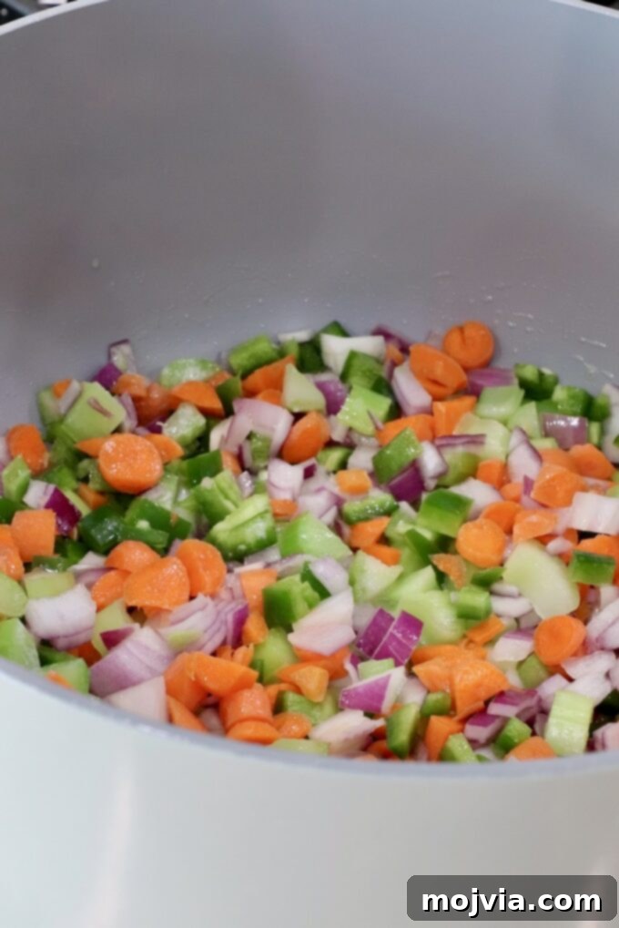 Buffalo Chicken Pot Pie
Savory Buffalo Chicken Pot Pie Delight 4 Chopped vegetables, including carrots, green peppers, onions, and celery, in a large gray pot