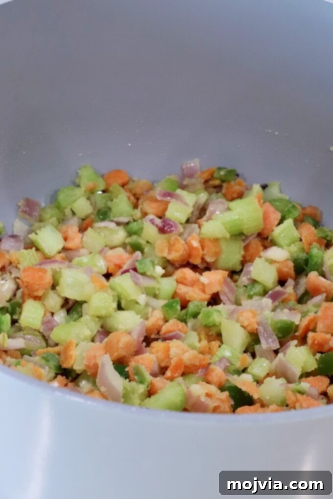 Buffalo Chicken Pot Pie
Savory Buffalo Chicken Pot Pie Delight 5 Chopped vegetables, including carrots, jalapeno peppers, onions, and celery, in a large gray pot, covered in flour