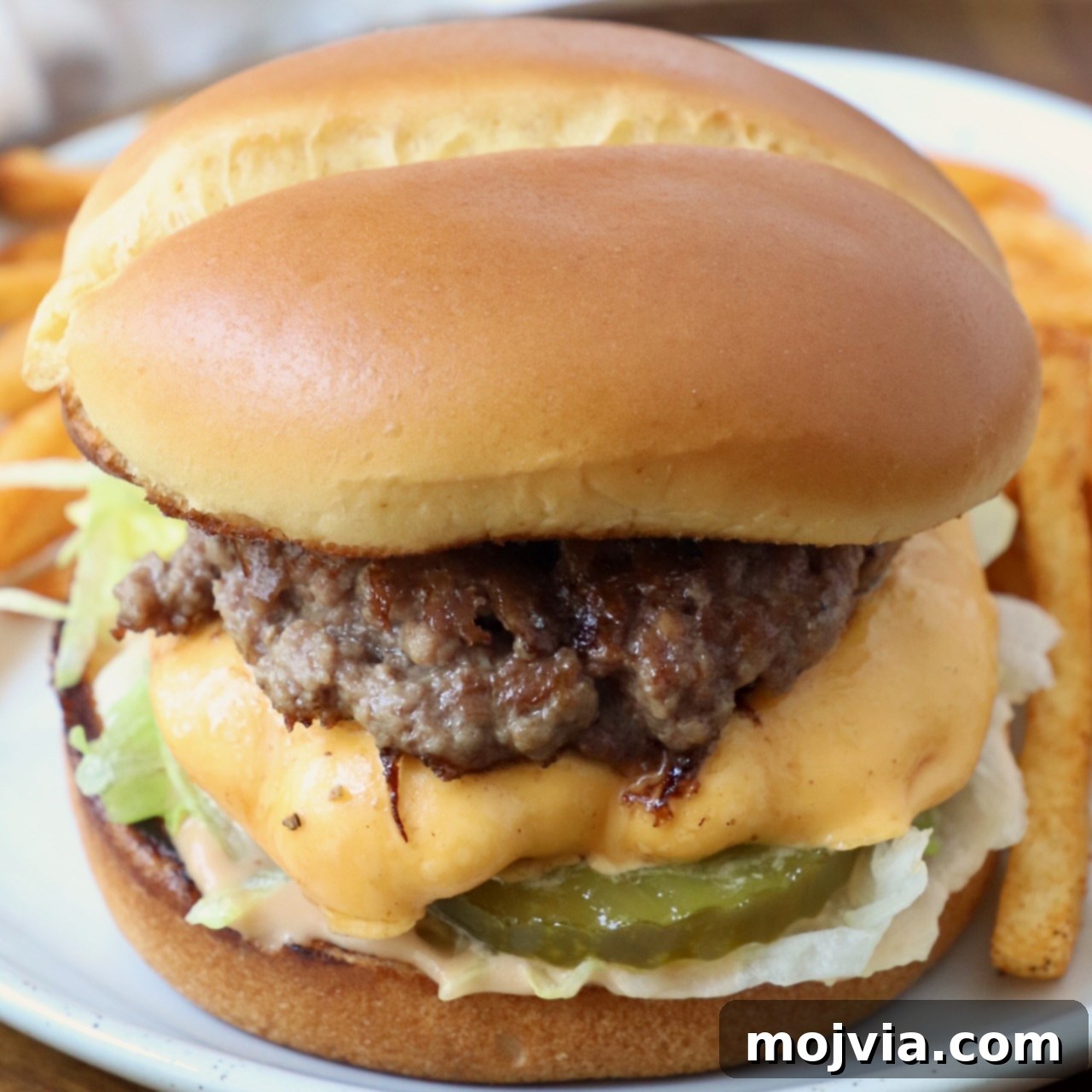 Smash burger on plate with fries