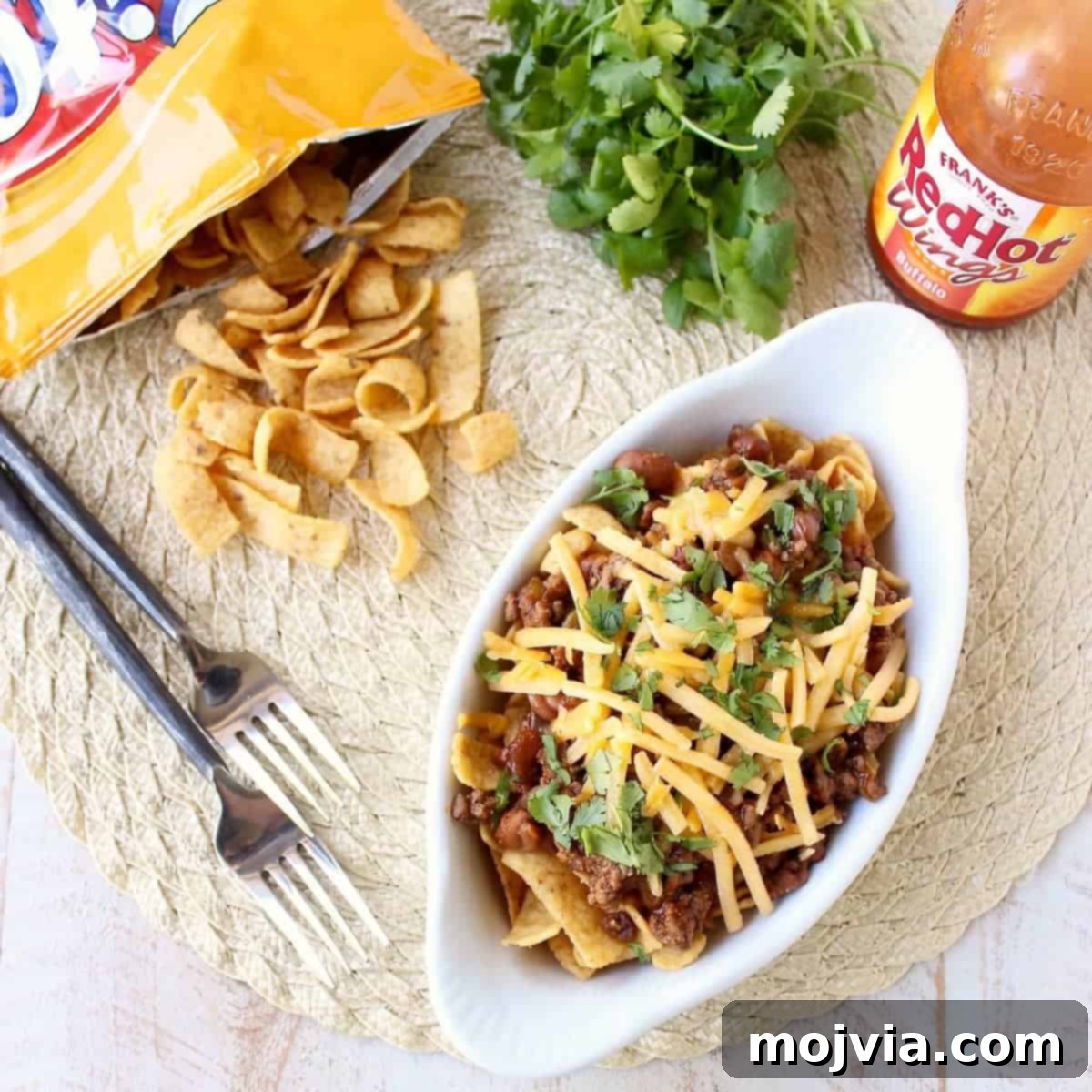 Frito Chili Pie is given a spicy kick with the addition of buffalo sauce, green chilies and spices in this delicious twist on a classic recipe, easy to make in only 20 minutes!