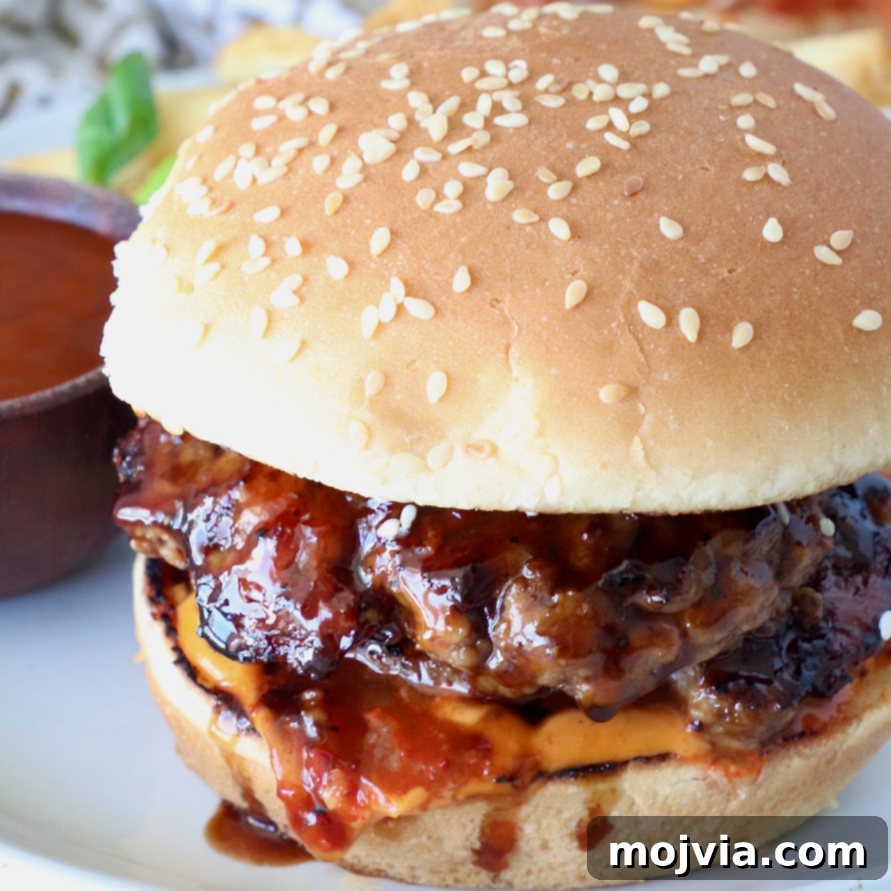burger covered in bbq sauce on a plate